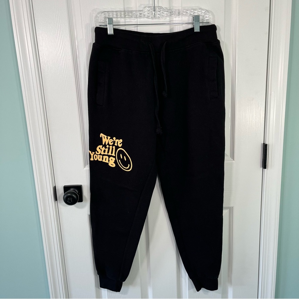 We’re Still Young Fanjoy black sweatpants yellow smiley face size small pockets